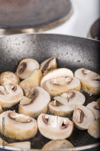 Frying sliced mushrooms in the frying pan