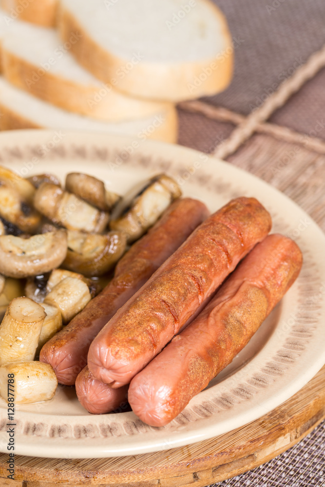 Fried sausages with sliced fried mushrooms Fried sausages with sliced fried mushrooms