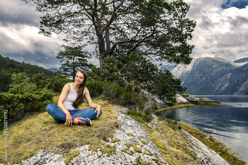 Young and sporty woman posing on the rocks  Norway