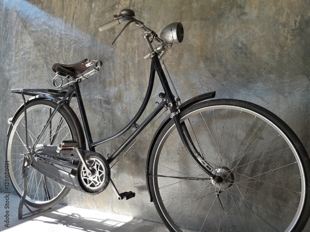 Classic Bike,Bicycle vintage style on Concrete wall in dark tone.