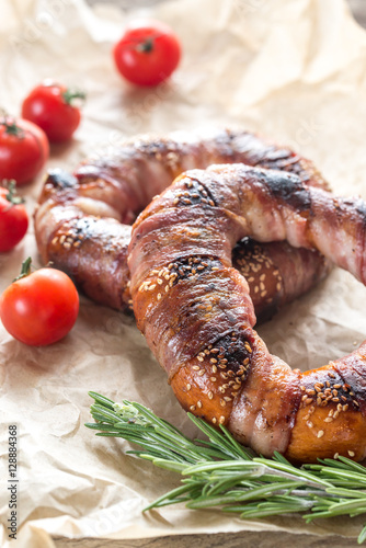 Bagels with sesame wrapped in bacon rashers photo