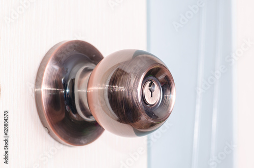 round door handle with a latch on a background of pink door