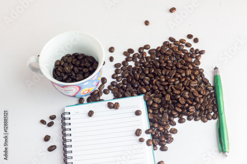 Close up coffee beans and and paper on with table
