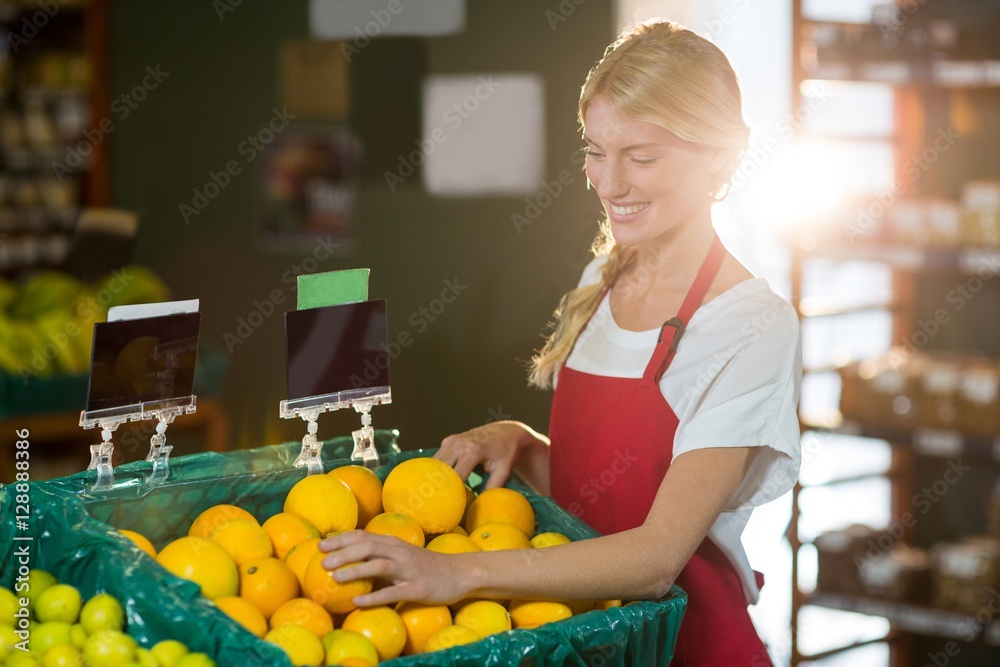 Female staff checking fruits in organic section