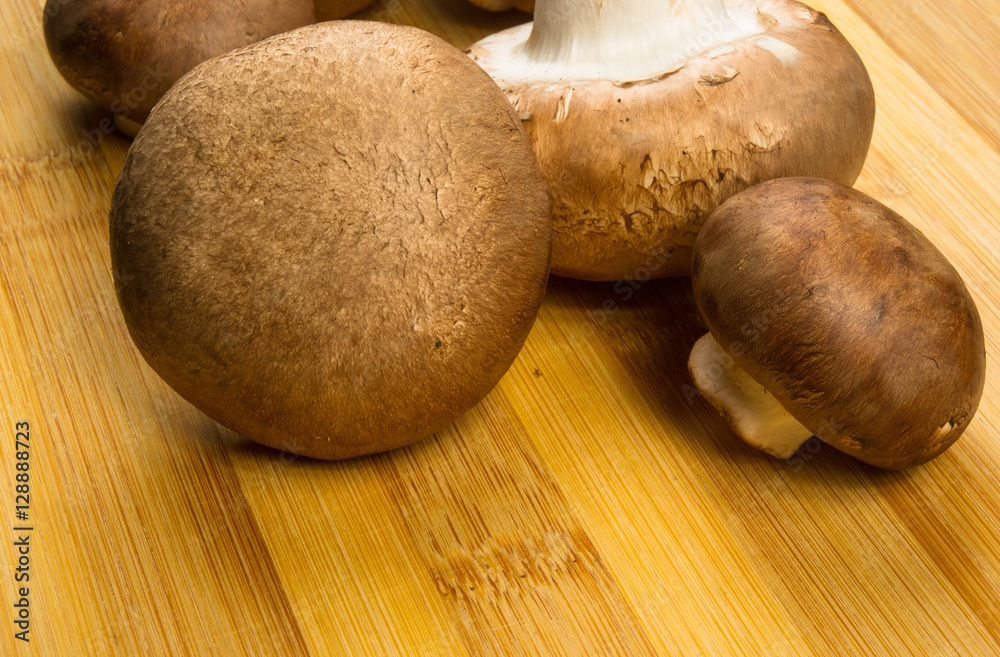 mushroom champignons on a wooden Board
