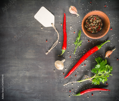 Parsley dill pepper and garlic in a dark wooden table. View from above. Space for text.