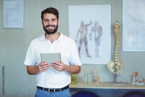 Portrait of physiotherapist holding a digital tablet