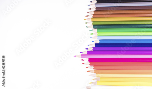 Jagged row of coloured pencils on white with space for text