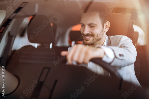 Handsome businessman driving car photo