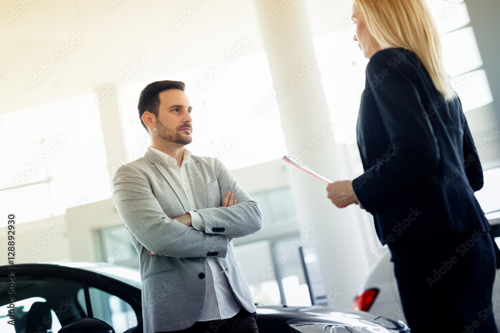 Salesperson selling cars at dealership Salesperson selling cars at dealership