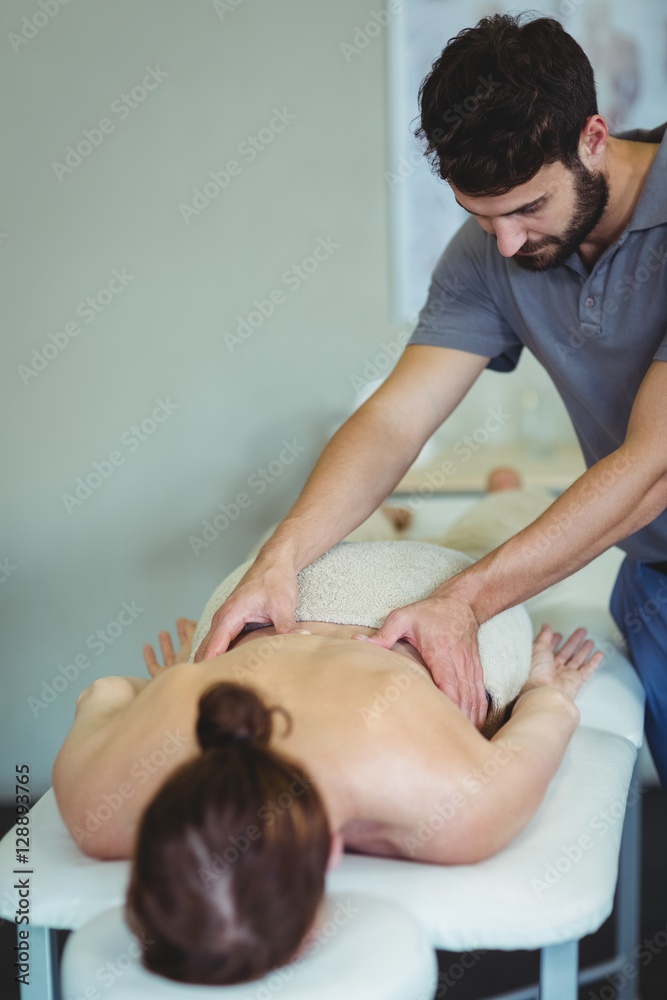 Fototapeta premium Physiotherapist giving back massage to a woman