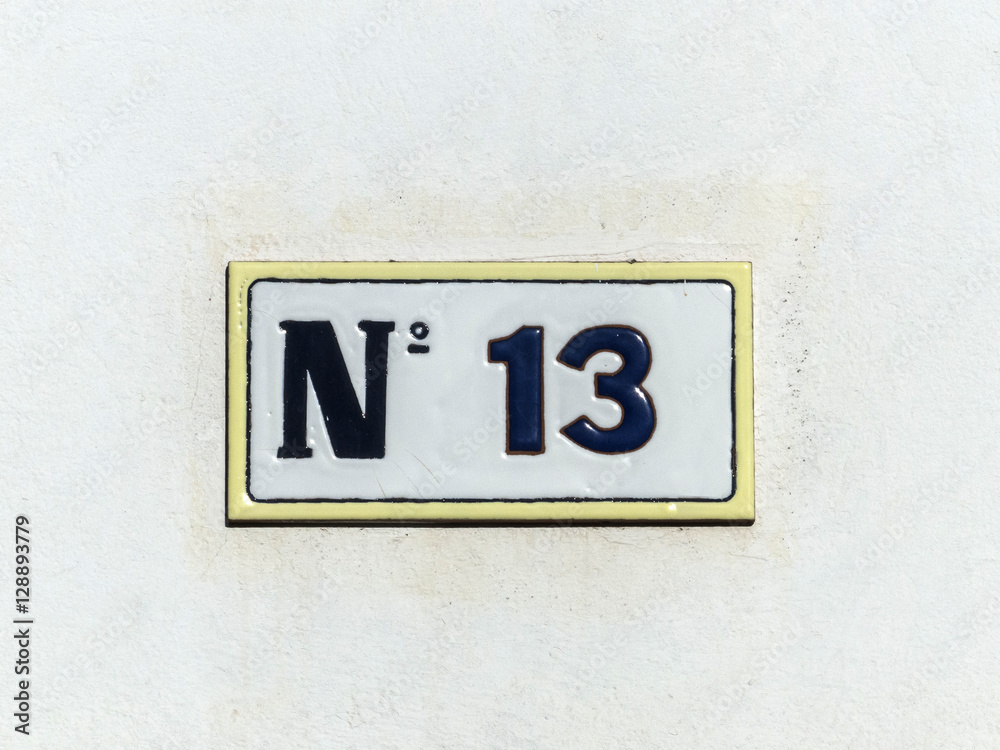 Street sign reading the number thirteen. Street sign reading the number thirteen.