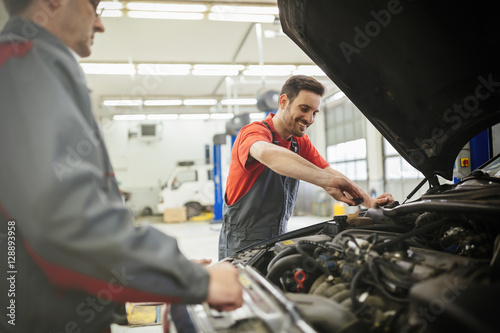 Car mechanics working and maintaining car