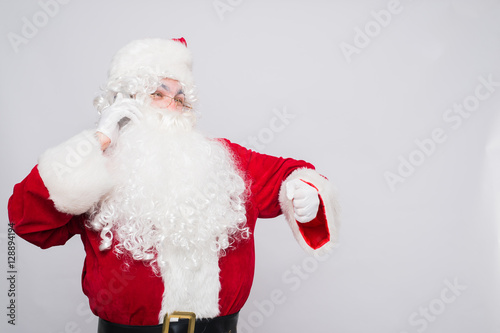 Santa Claus talking mobile Phone and look on the Watch