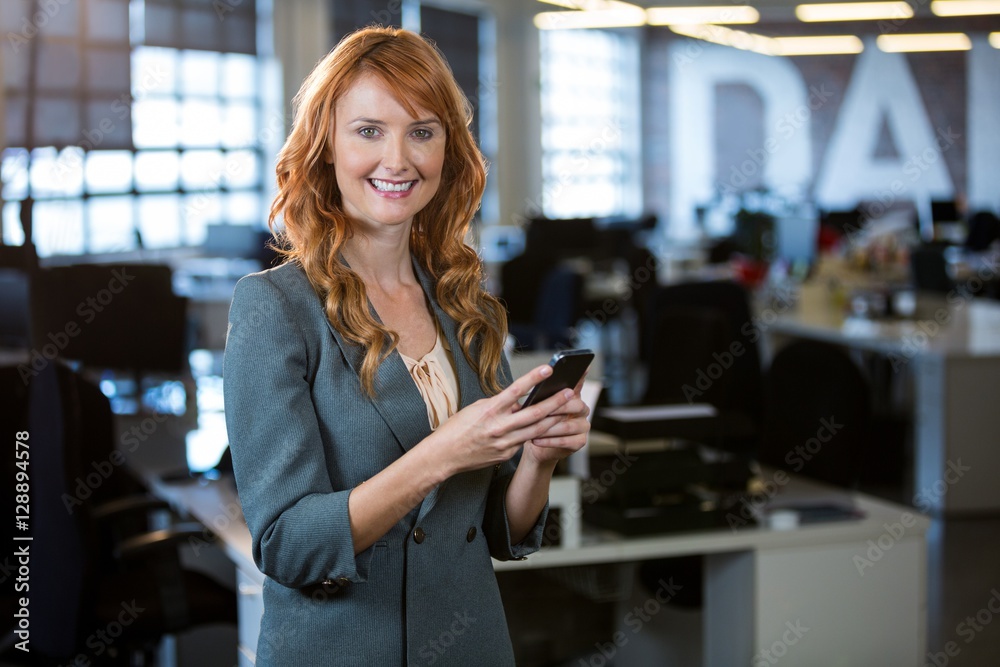 Smiling businesswoman using cellphone Smiling businesswoman using cellphone