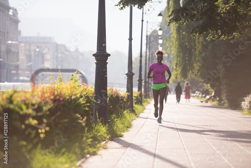 african american woman jogging in the city