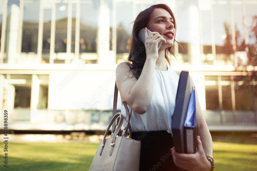 Businesswoman outdoors using phone Businesswoman outdoors using phone