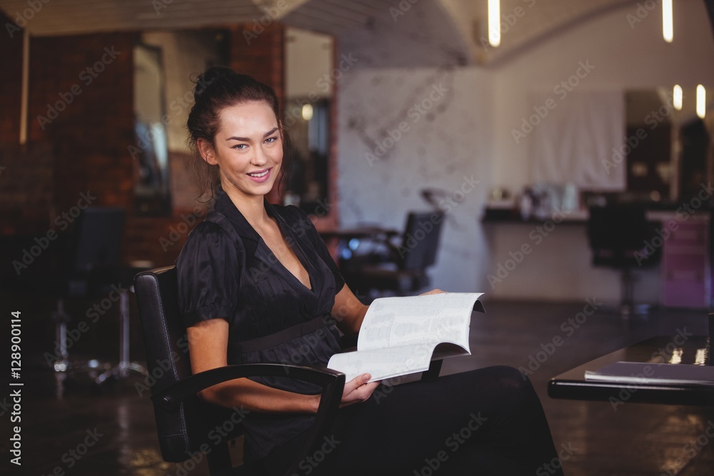Portrait of a woman holding a magazine at the hair salon Portrait of a woman holding a magazine at the hair salon