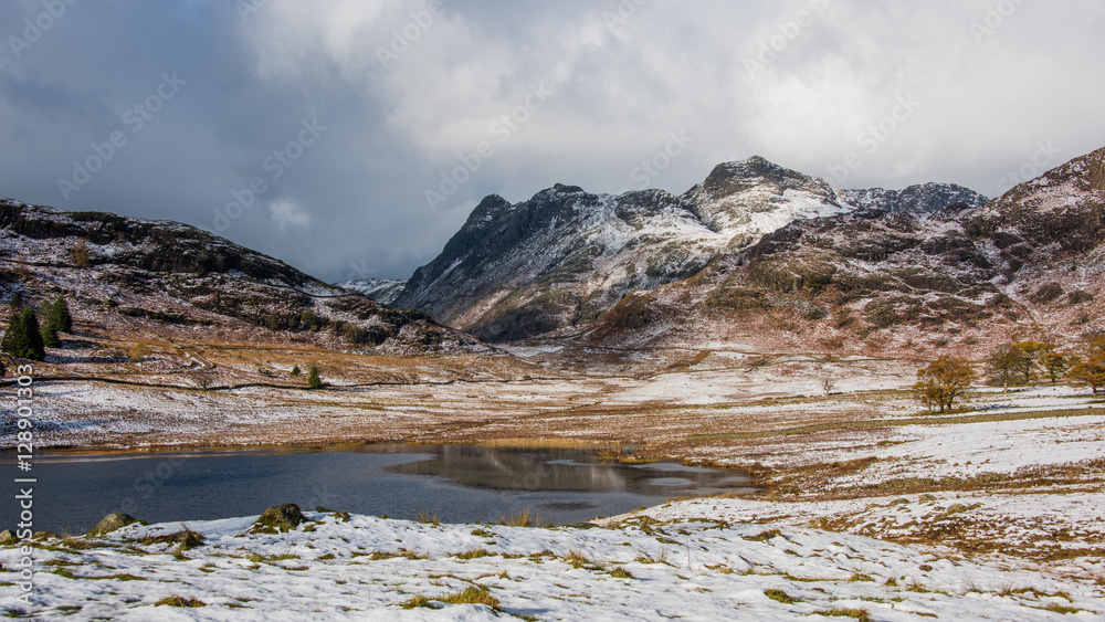 Wintery scene taken at Blea Tarn in Cumbria on the Little Langdale to Great Langdale road. It has a backdrop of the Langdale Pikes