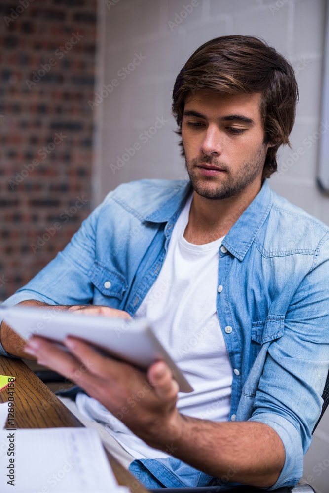 Businessman using digital tablet in office Businessman using digital tablet in office