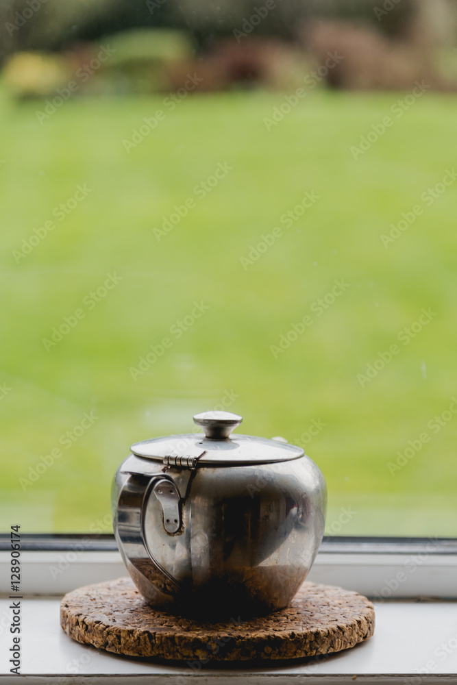 Single alone tea pot at window in kitchen Stock-Foto | Adobe Stock