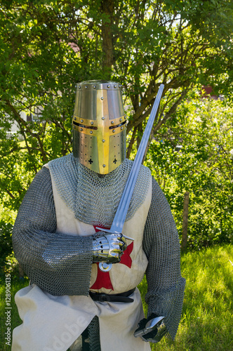 A person dresses up historically to mimic a knights templar in full armour photo
