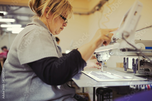 Worker in textile industry sewing