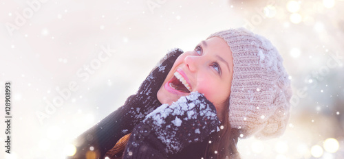 Winter girl portrait. Joyful teenage model girl having fun in winter park