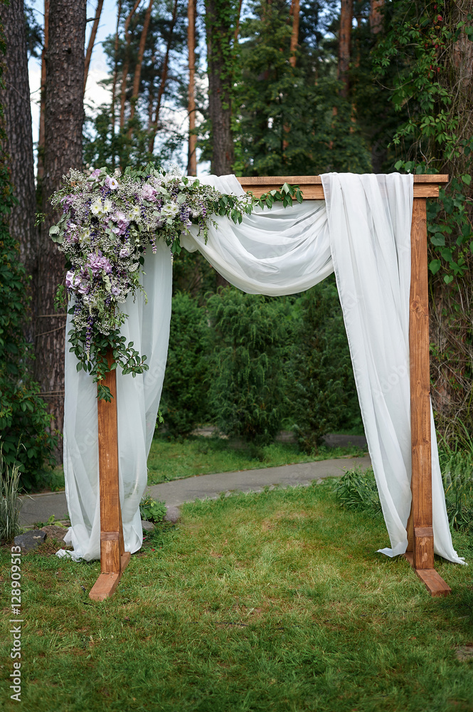 Beautiful wedding arch decorated with flowers in the Park Beautiful wedding arch decorated with flowers in the Park