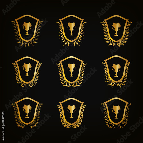 Set of luxury golden shields with laurel wreaths, champion cups. Filigree elements, award, emblem, icon, symbol, logo for web, page design Vector illustration EPS10