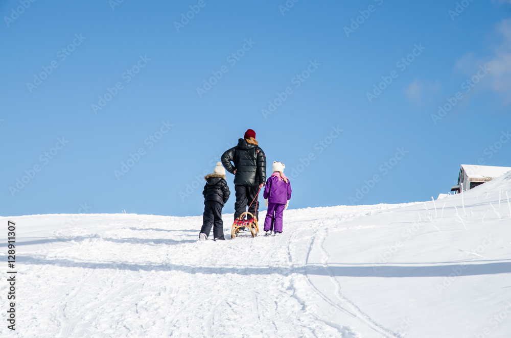 man with kids in winter time