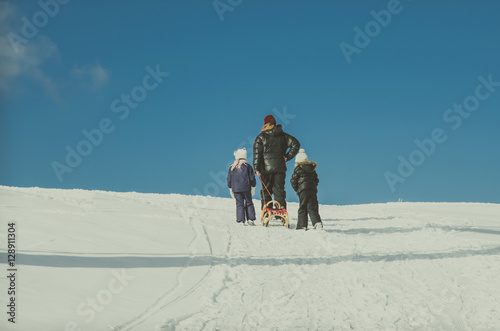 man with kids in winter time
