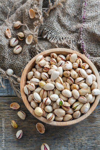 Pistachios in a wooden bowl.