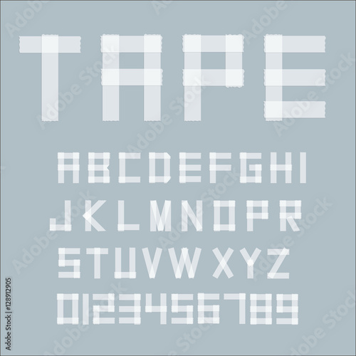 White transperent adhesive tape letters isolated on grey background.