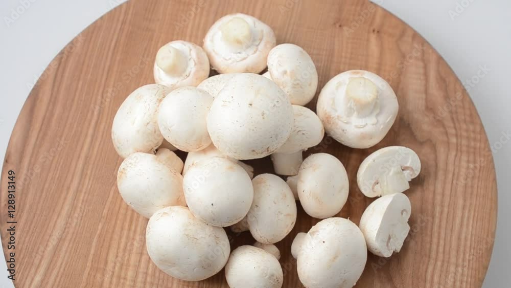 Mushrooms on a wooden board. Fresh champignons. Mushrooms on a wooden board. Fresh champignons.