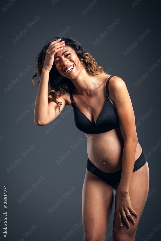 Obraz premium Beautiful Pregnant African American Woman Wearing Black Laughing