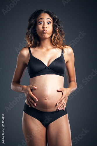 Beautiful Pregnant African American Woman Wearing Black Holding Belly © BestStockFoto