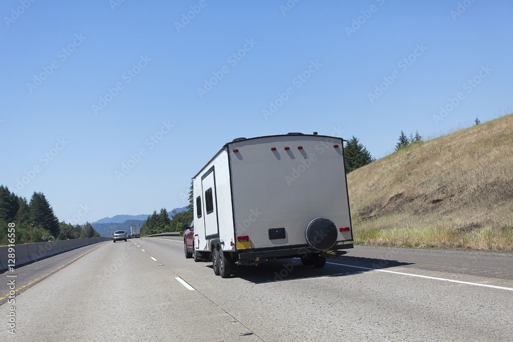 Rear view of vacation camper on highway. Horizontal. Rear view of vacation camper on highway. Horizontal.