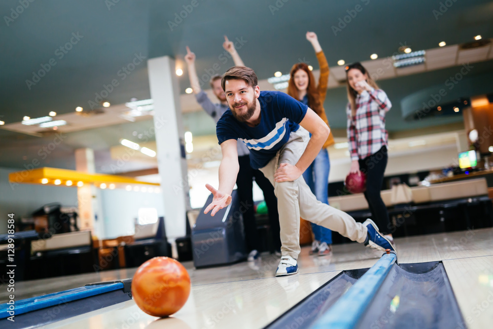 Fototapeta premium Friends enjoying bowling at club