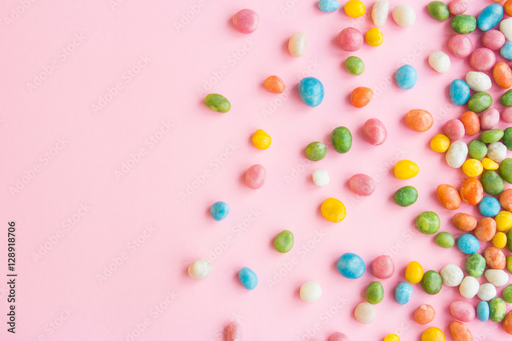 Sweets scattered on pink background
