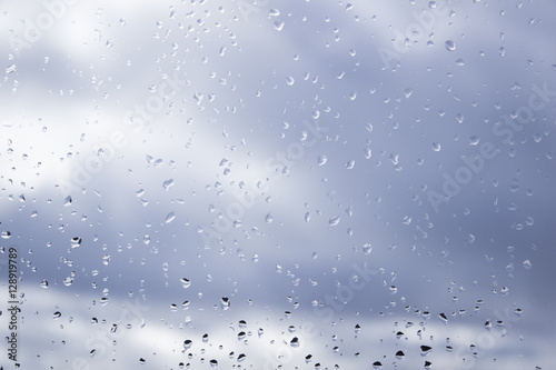 Rain drops on window on a cloudy day