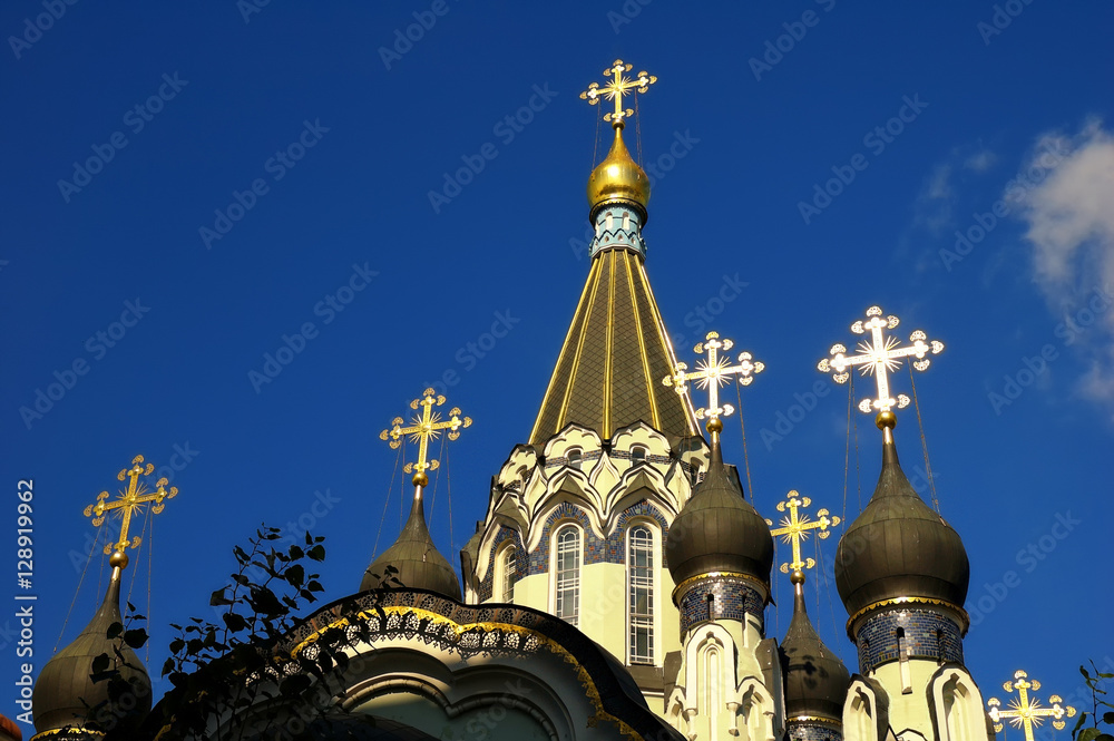 The domes and Golden crosses on the background of blue sky on the Church of the Resurrection in Sokolniki, Moscow, Russia. Horizontal view