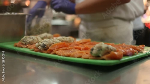 Close up of chef preparing fish in a restraurant.  Seafood in the food and service industry. photo