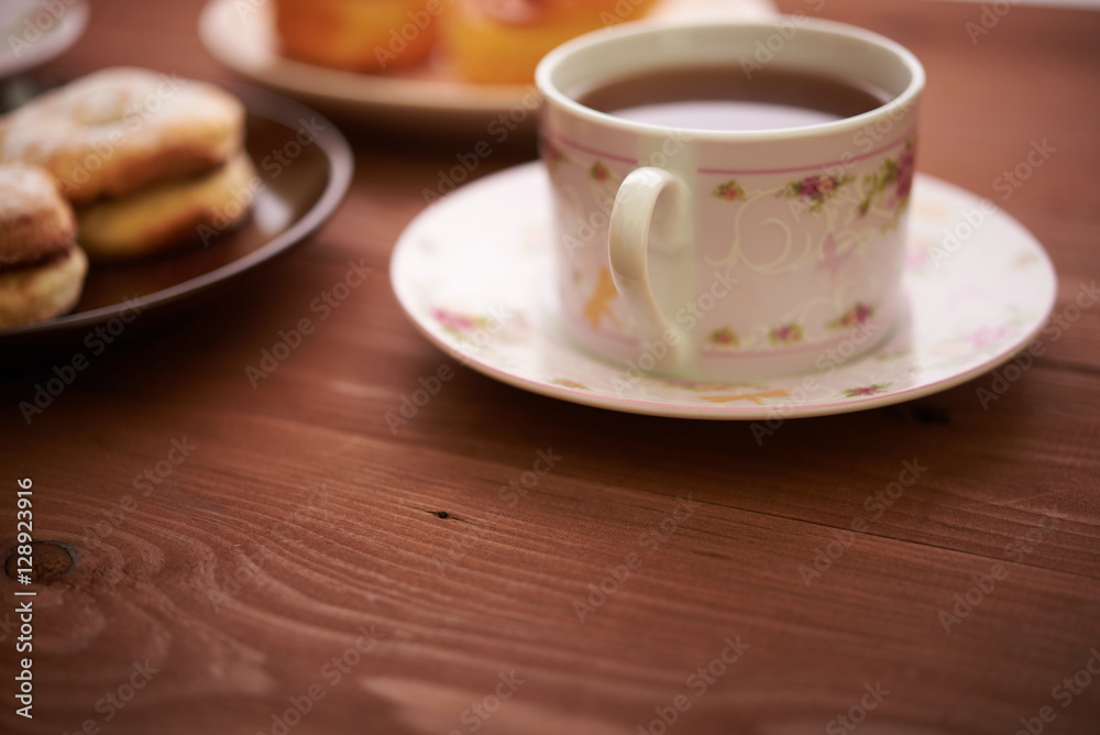 Fototapeta premium tea and sweets on a wooden table