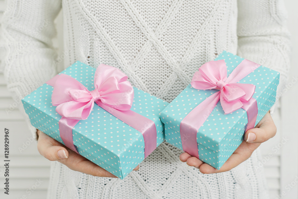 Female hands holding gift boxes Female hands holding gift boxes