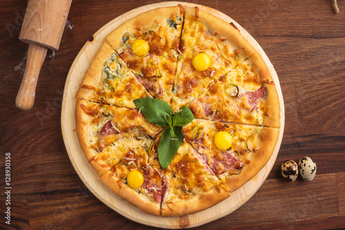 Concept: restaurant menus, healthy eating, homemade, gourmands, gluttony. Pizza carbonara on a wooden vintage table with ingredients. Top-down view