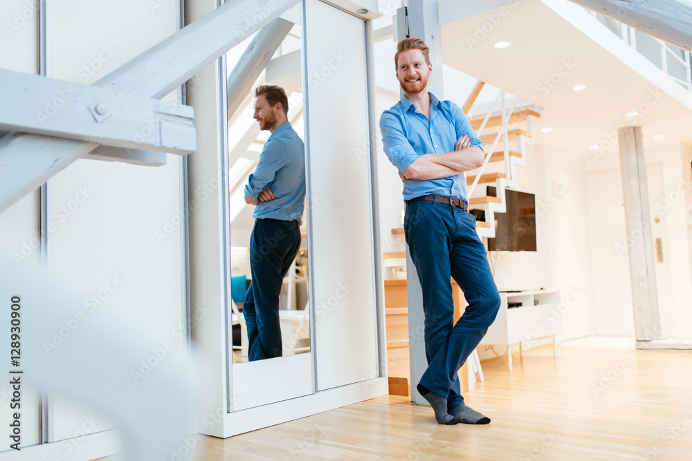 Confident businessman relaxing at home Confident businessman relaxing at home