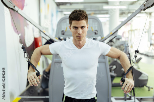 Handsome man training in clean modern gym