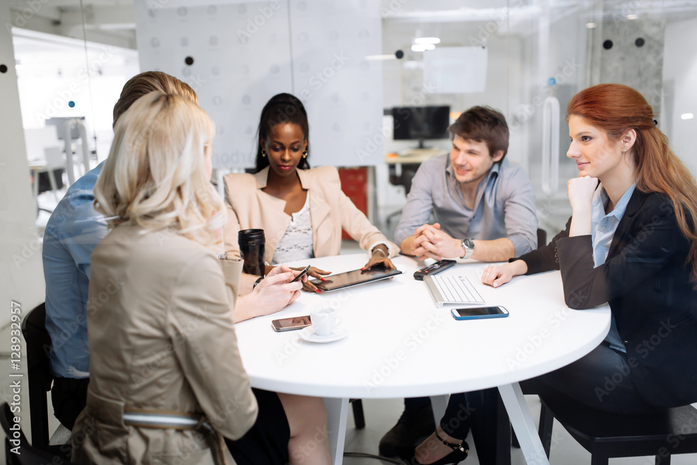 Group of business people sitting at desk Group of business people sitting at desk