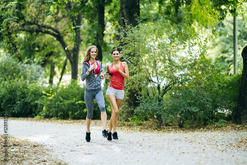Young fit women jogging outdoors © NDABCREATIVITY